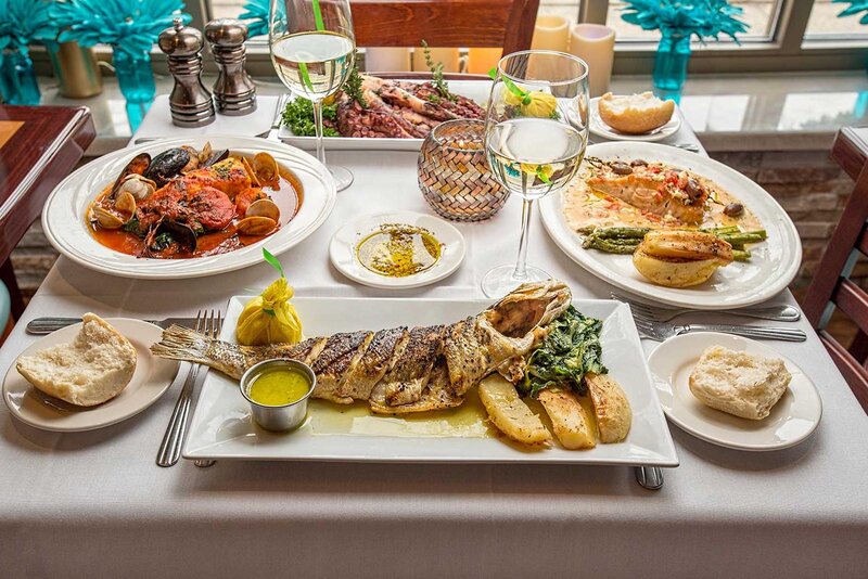 Seabass entree on set table with other entrees