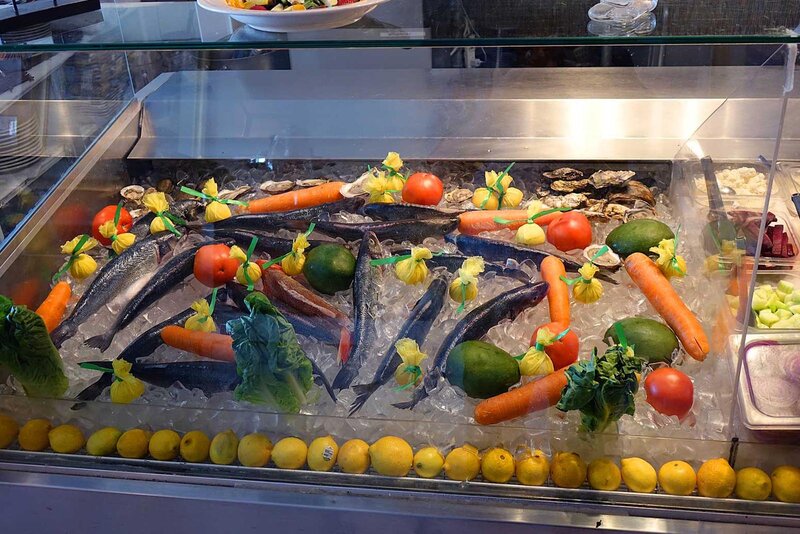 Fresh fish and vegetables on a bed of ice in a display case